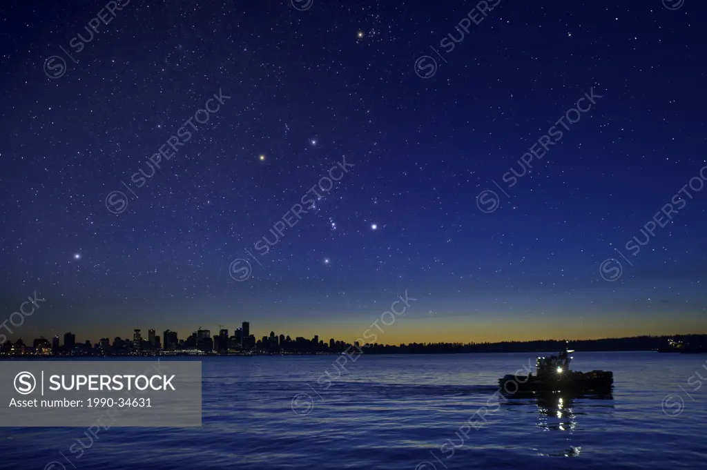 The constelation Orion setting after dusk over the vancouver skyline.