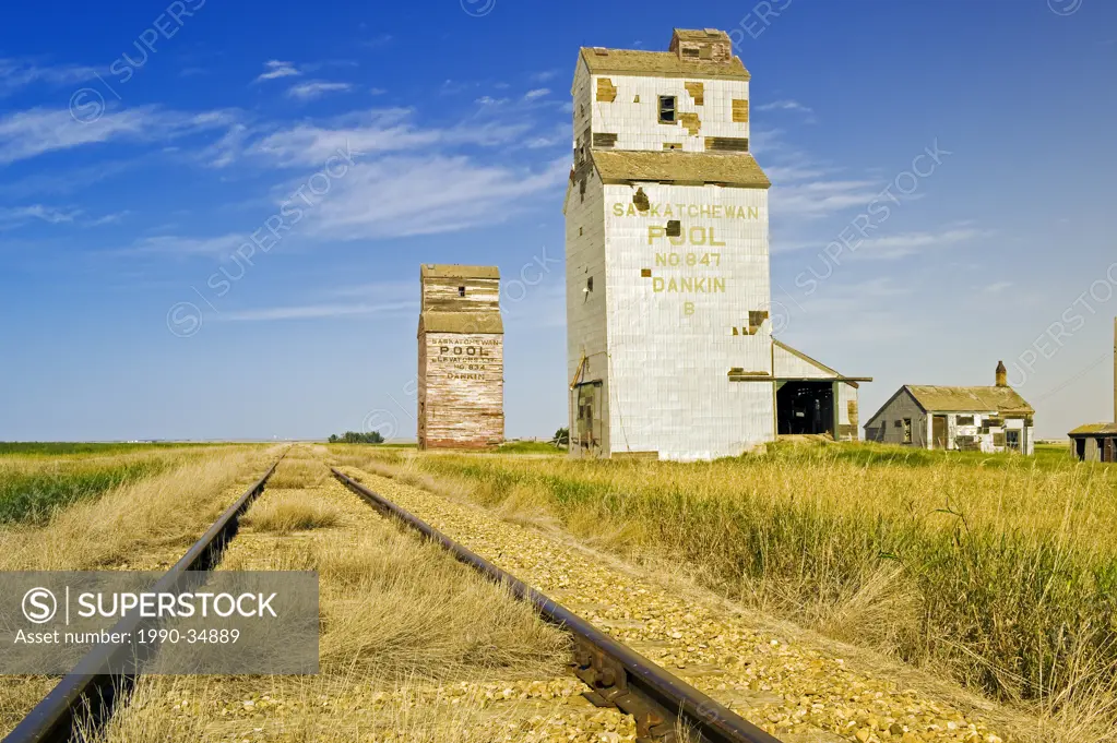 railway with abandoned elevators in the background, Dankin, Saskatchewan, Canada