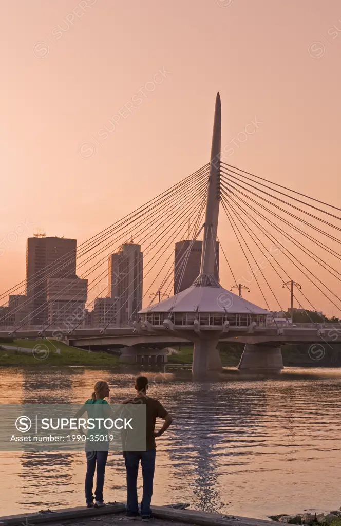 couple on St Boniface dock with Winnipeg skyline and Red River in the background, Manitoba, Canada