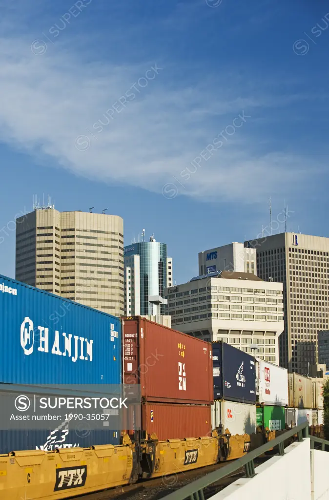 a train carrying shipping containers passes through downtown Winnipeg, Manitoba, Canada