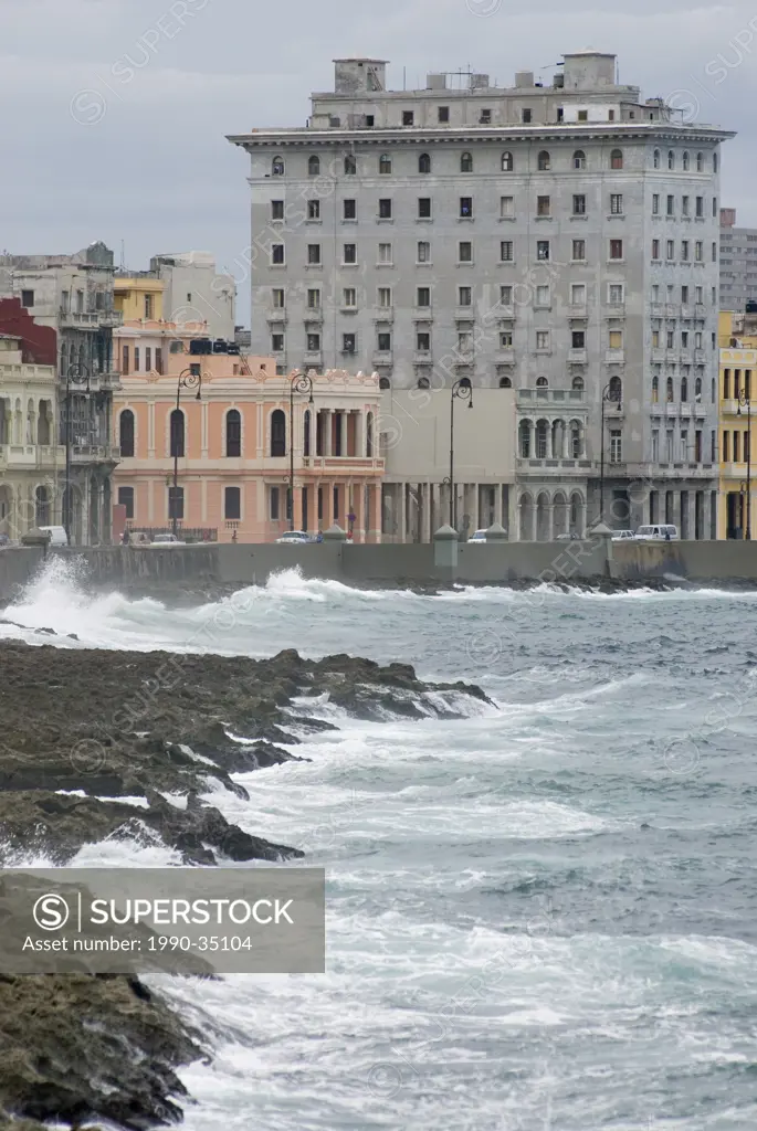 Waves crash along the walls of the Malecon in Havana Cuba
