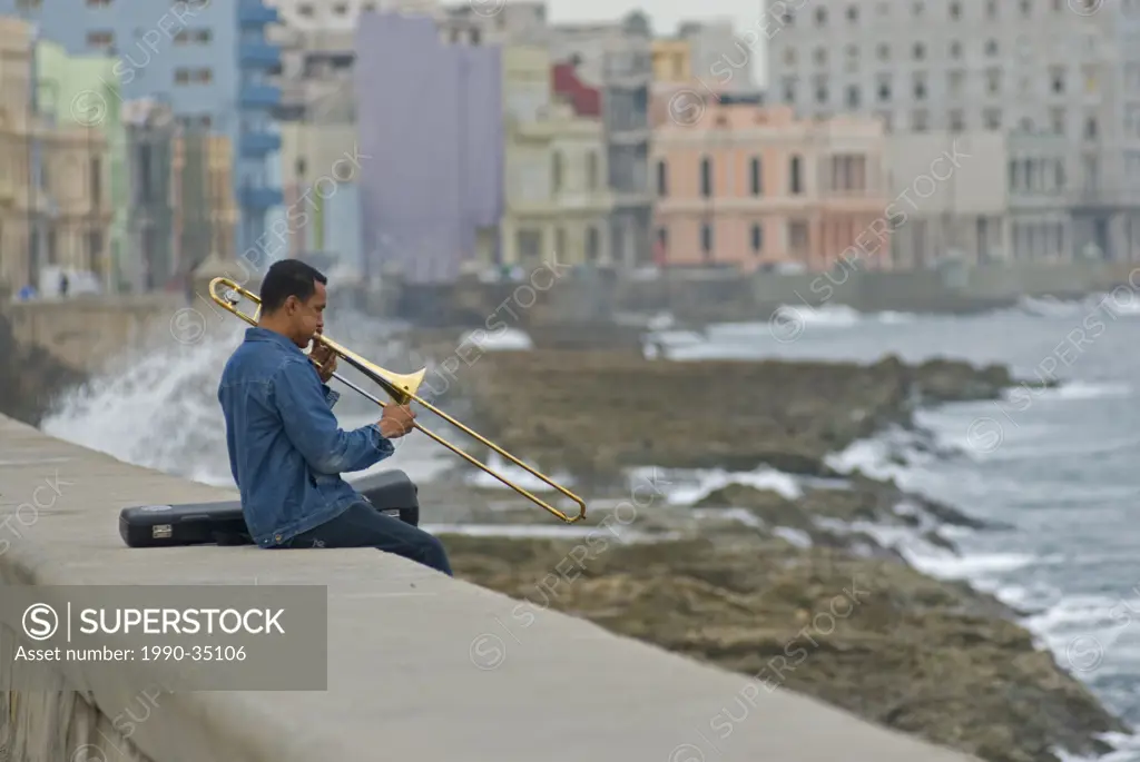 A man playing the trombone on the Malecon Havana Cuba