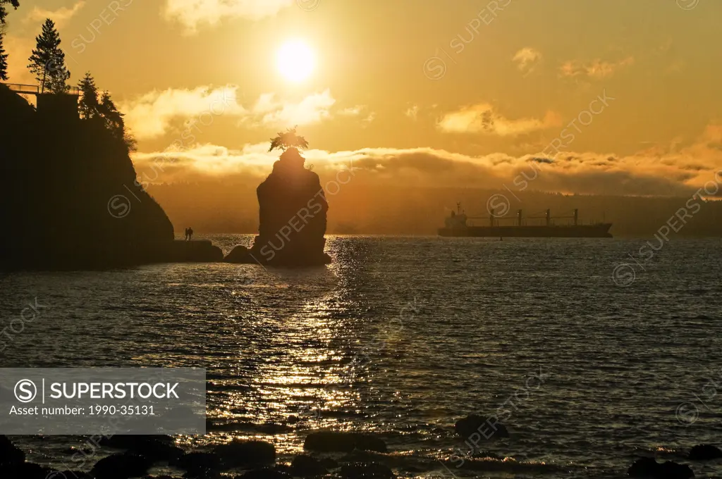 Stanley Park seawall at sunset by Siwash Rock, Vancouver, British Columbia, Canada