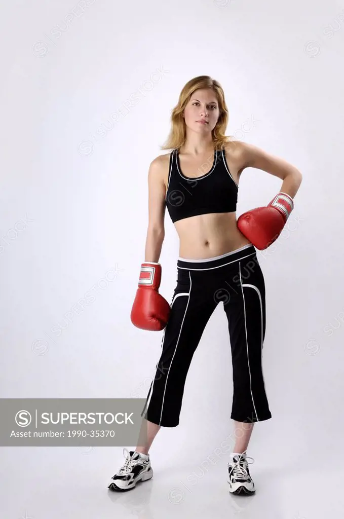 Young woman in boxing gloves isolated on white background