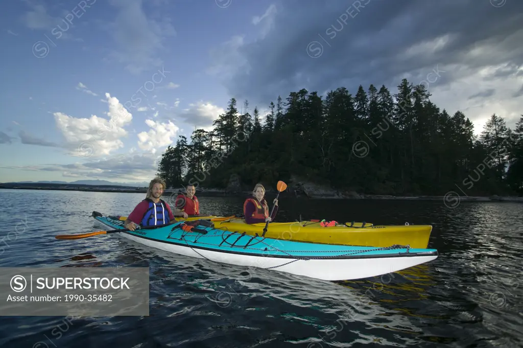 Two kayaks paddle in tandem while exploring the Breton Island´s, a short paddle from Quadra Island´s Rebecca Spit. Breton Island´s, Quadra Island, Bri...