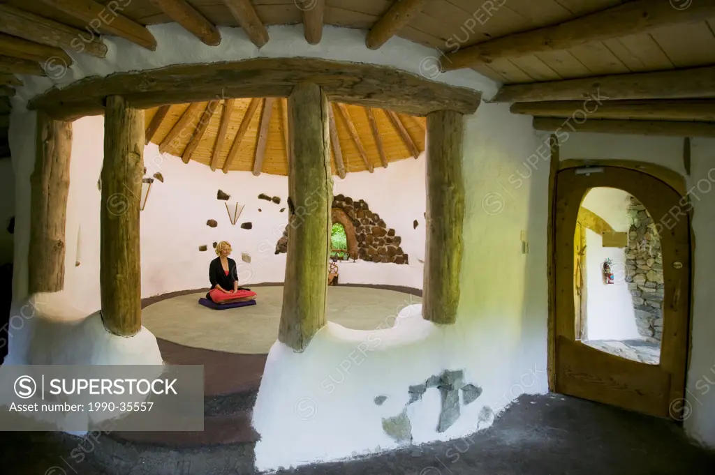 A young woman begins meditation at Sanctuary, an adobe type structure on the grounds of Hollyhock on Cortes Island. Cortes Island, Discovery Island´s,...