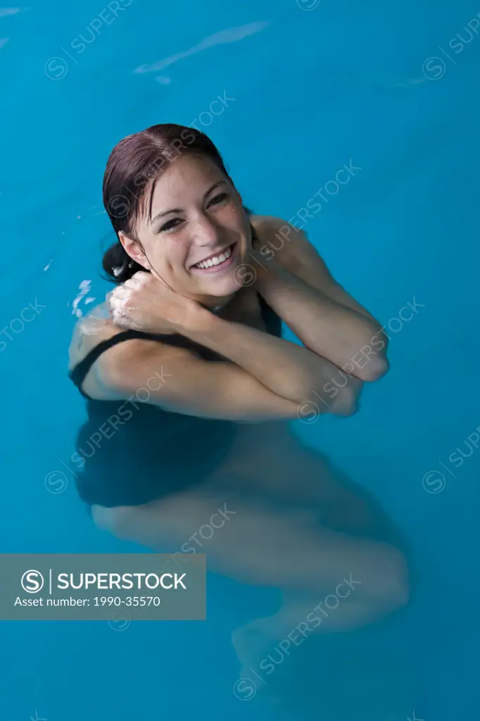 A young woman in a pool smiles while enjoying the warm water and exhilerating spa experience at the Kingfisher Resort & Spa. The Comox Valley, Vancouv...