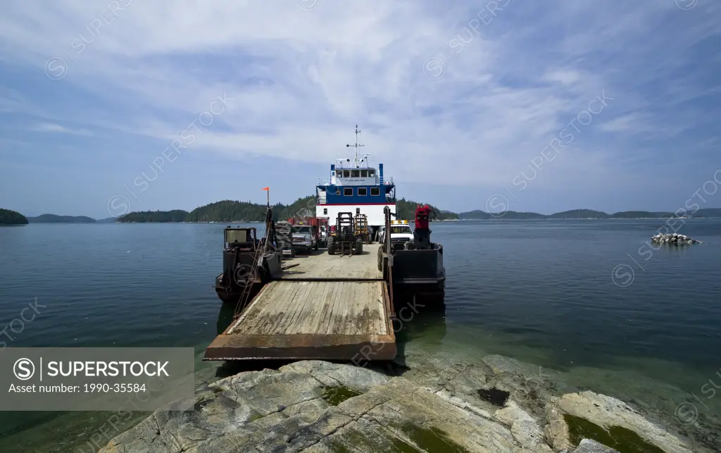 The MV Aurora, a 135 ft landing barge set it´s loading ramp onto the shores of Village Island to allow visitors a break and wait for tides. Village Is...