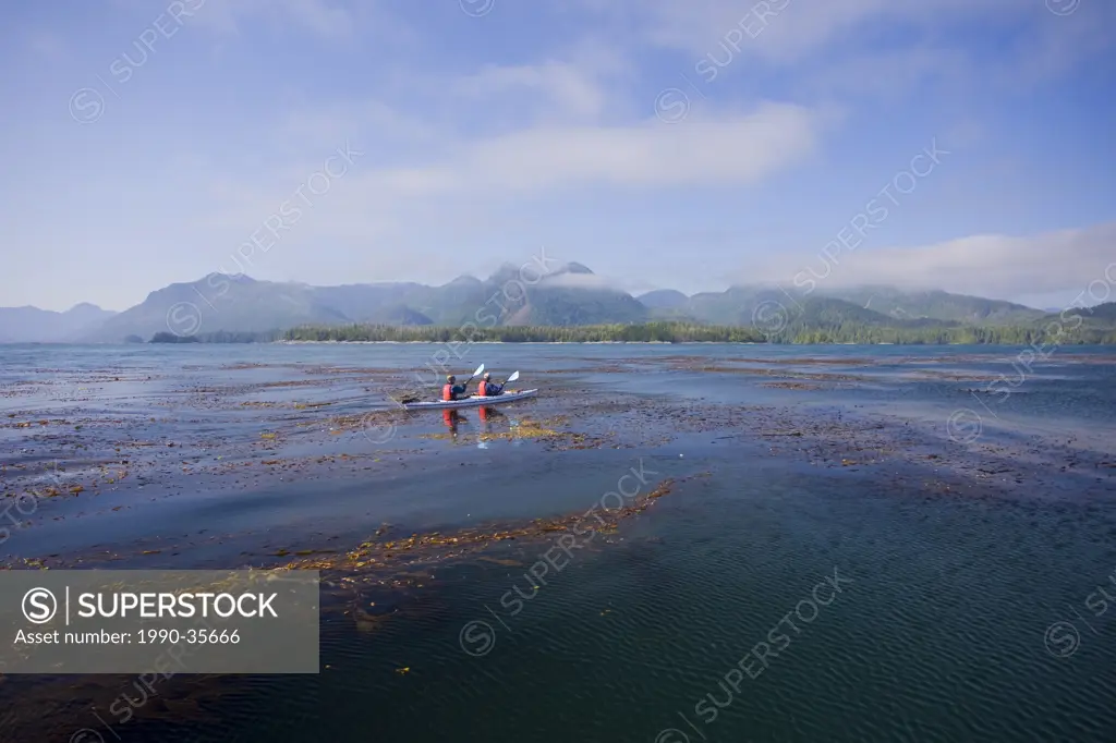 Kayakers paddle towards Spring Island after a foray into the open ocean in the Kyuquot Sound area on Vancouver Island´s Northern West Coast. Kyuquot S...