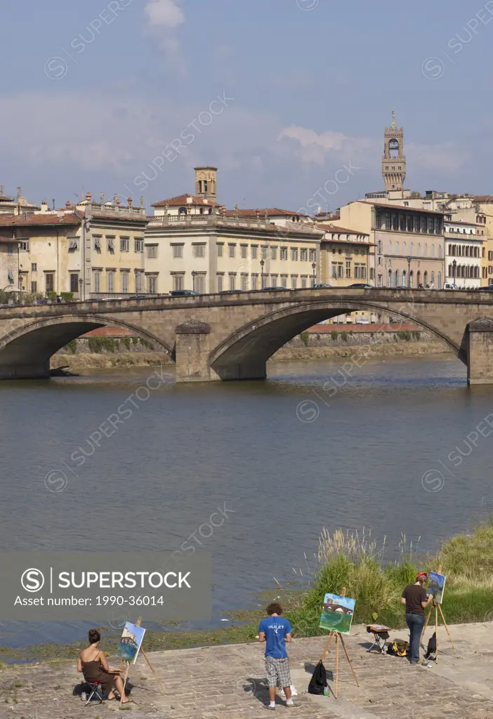 Art students paint by the Arno River, Florence, Tuscany, Italy