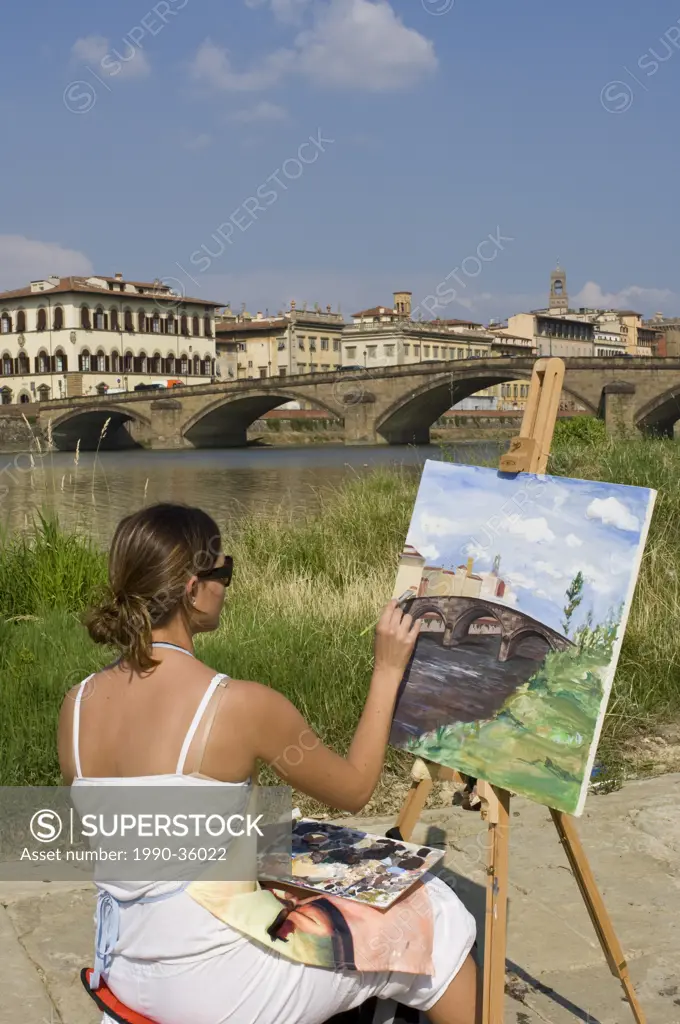Art students paint by the Arno River, Florence, Tuscany, Italy