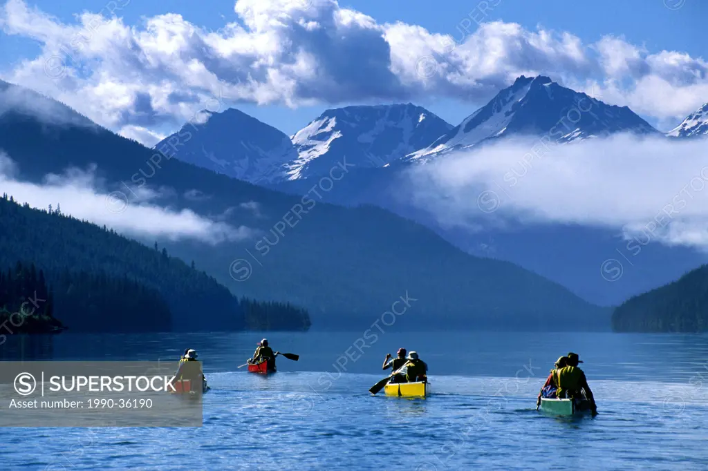 Canoeists paddling on Isaac Lake, Bowron Lake Park, British Columbia, Canada