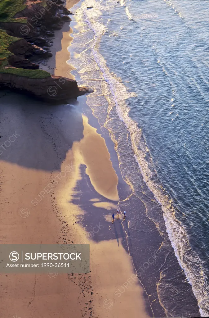Aerial view of people walking on the beach at sunset, Seaview, Prince Edward Island, Canada.