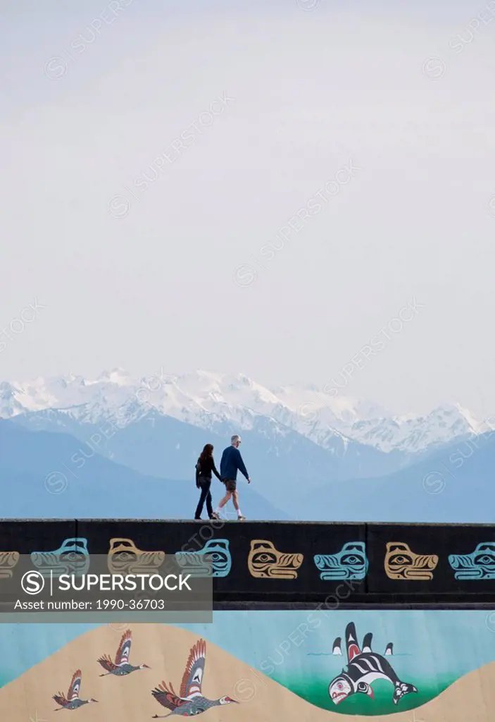 Ogden Point breakwall with First Nations murals and Olympic Mountains, Victoria, British Columbia, Canada