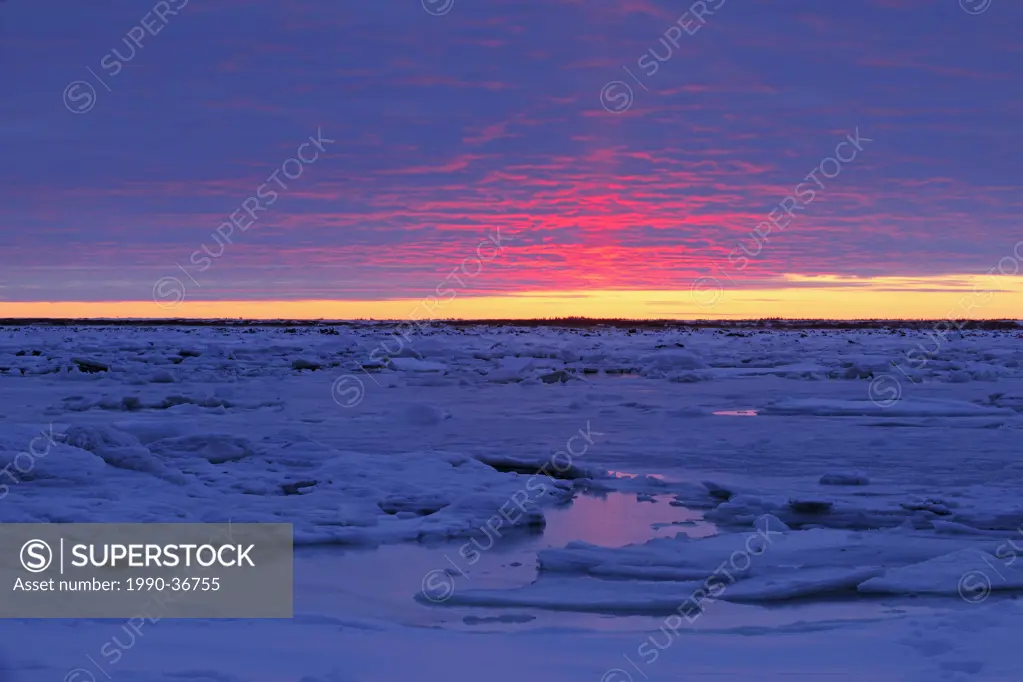Sunset over Hudson Bay lowlands in early winter. Seal River Heritage Lodge, Churchill, Manitoba, Canada.