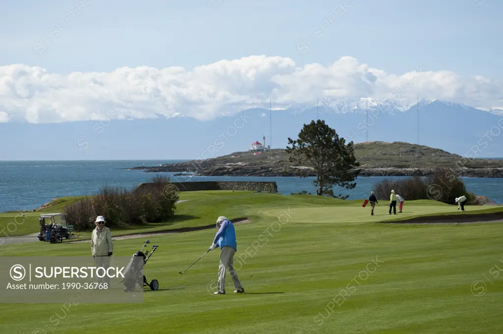 Senior female golfers at Victoria Golf Club, Trial Island and Olympic Mountains, Victoria, British Columbia, Canada