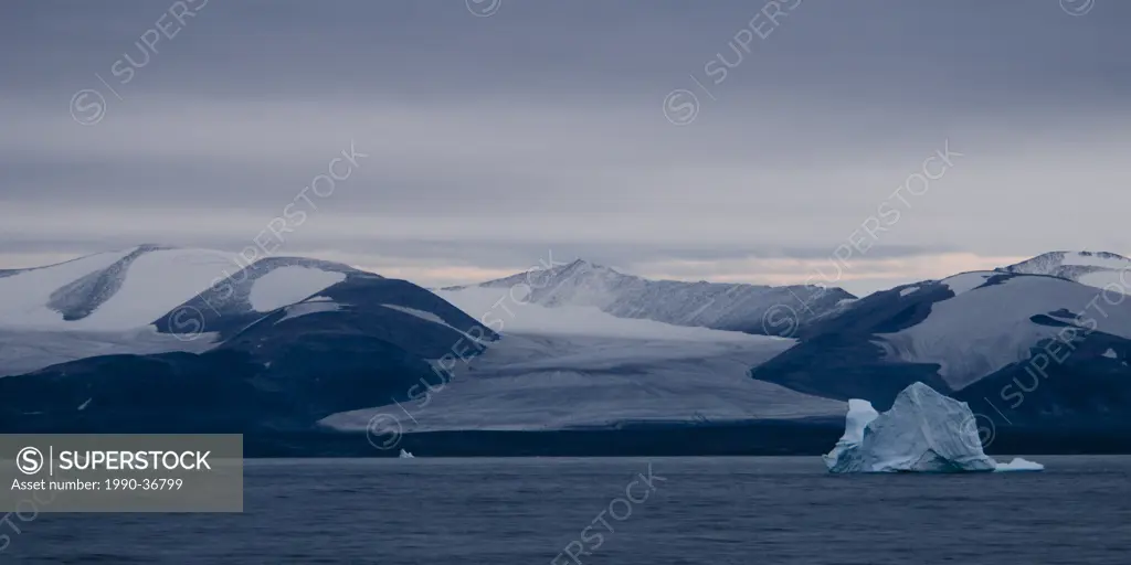 Icebergs and glacier at dusk, Baffin Island, near Pond Inlet, Nunavut, Canada.