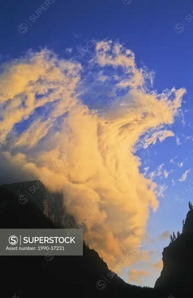 Dramatic storm cloud at sunset over Spray Gap, near Canmore, Alberta in the Canadian Rocky Mountains