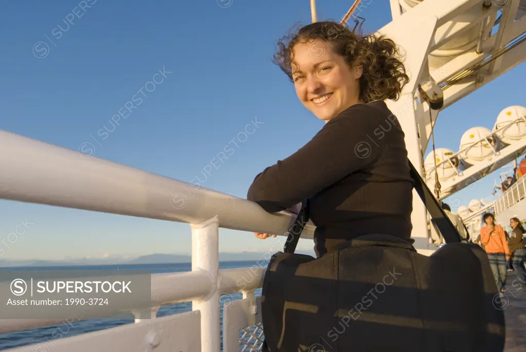 A Young Woman enjoys the view from a BC Ferry trip between Victoria and Vancouver British Columbia, Canada