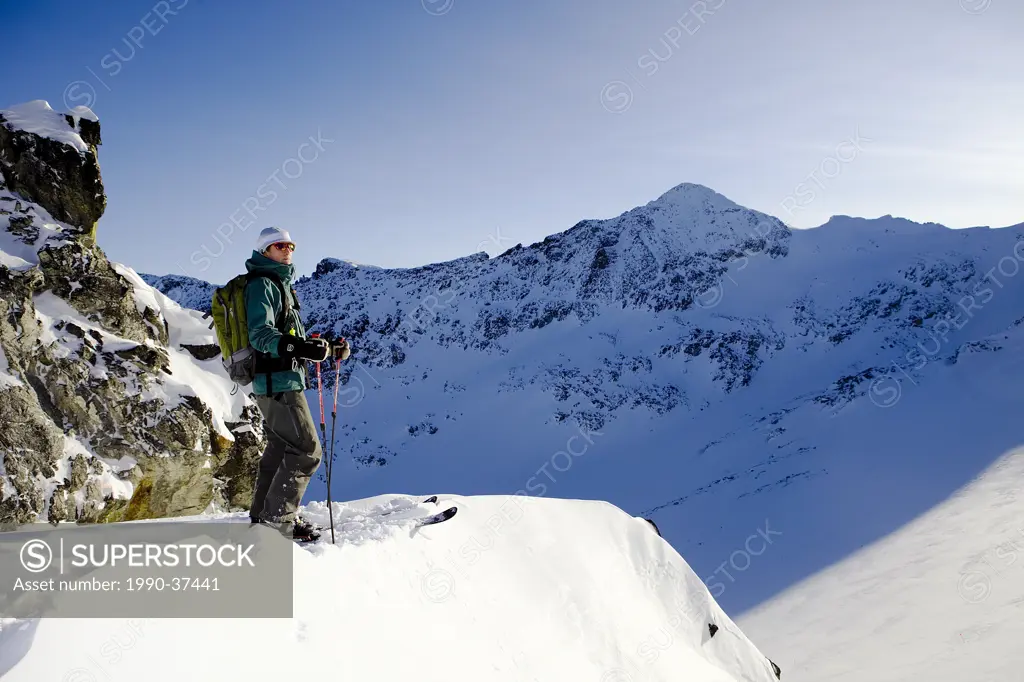 Man looking at the view in the Whistler backcountry, Coast Mountains, British Columbia, Canada.