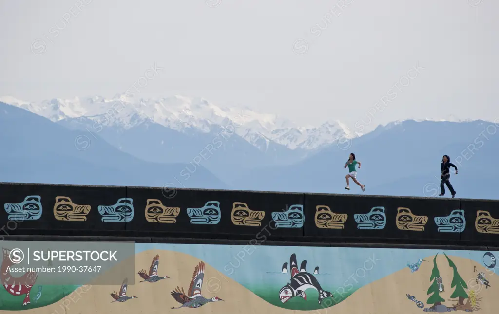 Ogden Point breakwall with First Nations murals and Olympic Mountains, Victoria, British Columbia, Canada