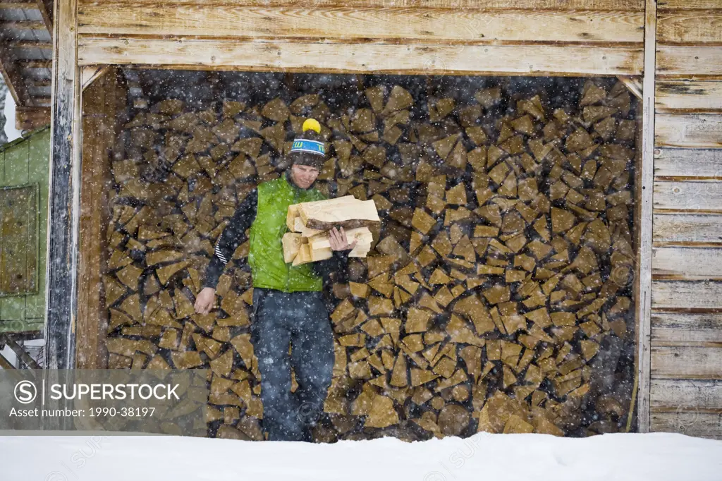 A man carrying firewood, Mount Assiniboine, Mount Assiniboine Provincial Park, British Columbia, Canada