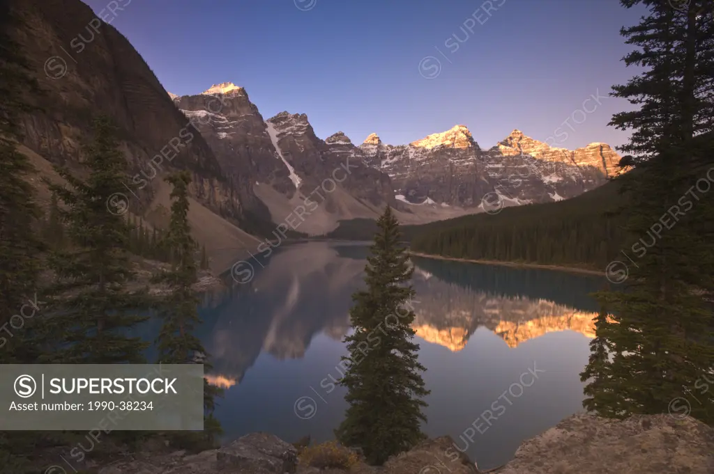 Sunrise at Moraine Lake showing mountain reflections, Valley of the the Ten Peaks, Banff National Park, Alberta, Canada.
