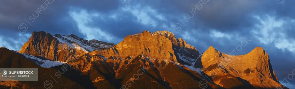 Panorama alpenglow on the Canadian Rockies at sunrise above the Town of Canmore, Alberta, Canada