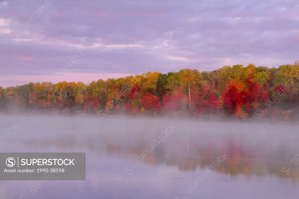 Autumn reflections in Gryphon Lake at dawn. Espanola, Ontario, Canada.