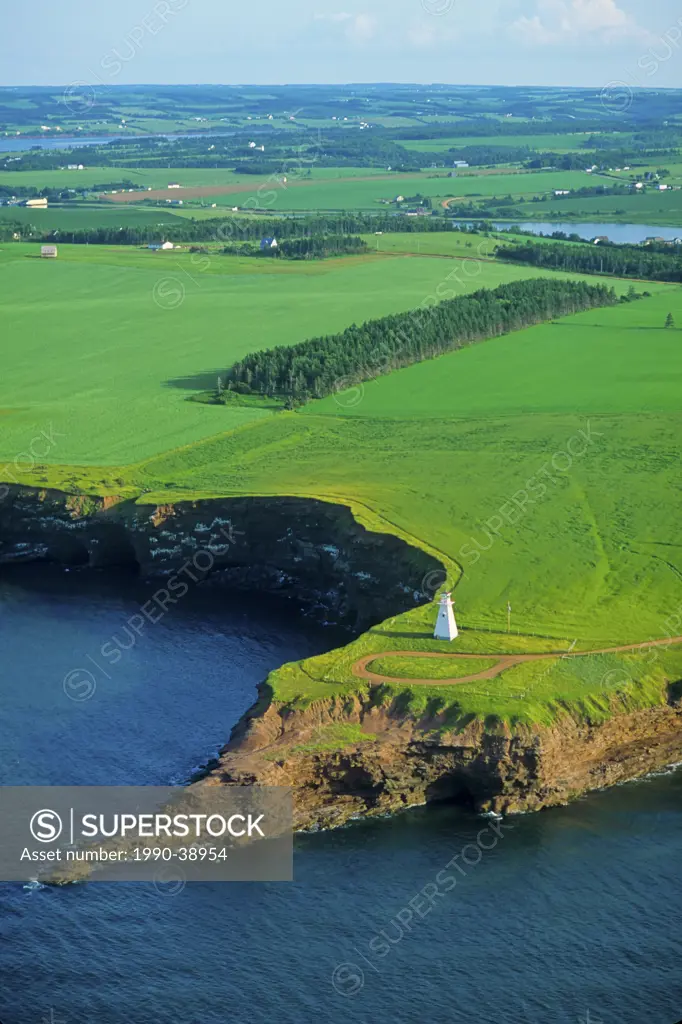Aerial view of Cape Tryon Lighthouse and farmland on the coast of Prince Edward Island, Canada.