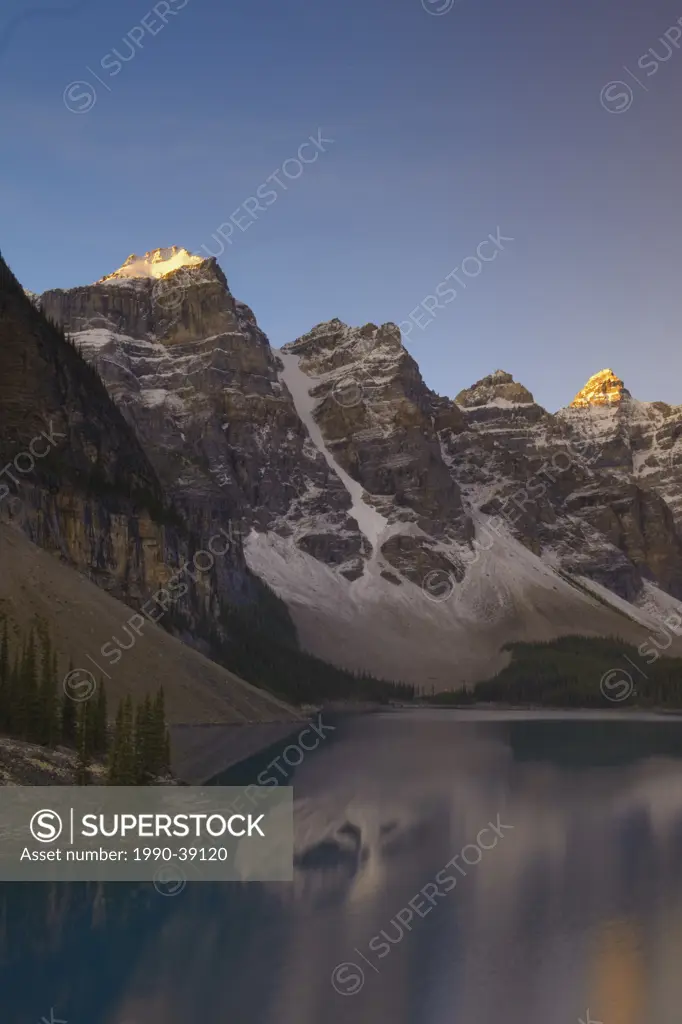 Sunrise at Moraine Lake showing mountain reflections, Valley of the the Ten Peaks, Banff National Park, Alberta, Canada.