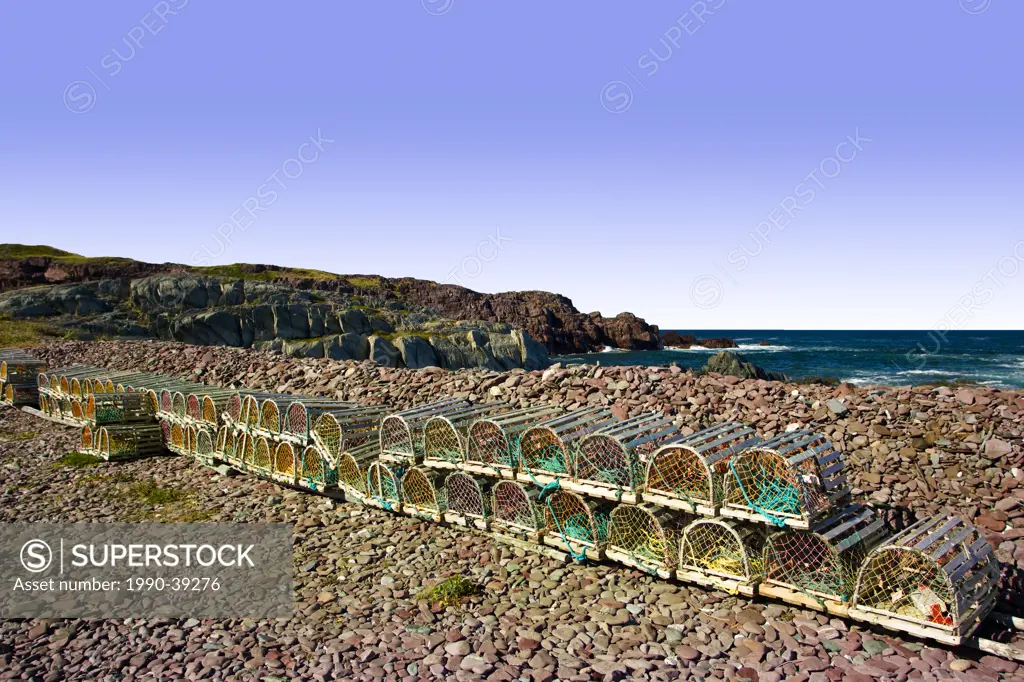 Lobster traps stacked and lined up on beach at Tickle Cove, Newfoundland and Labrador, Canada.