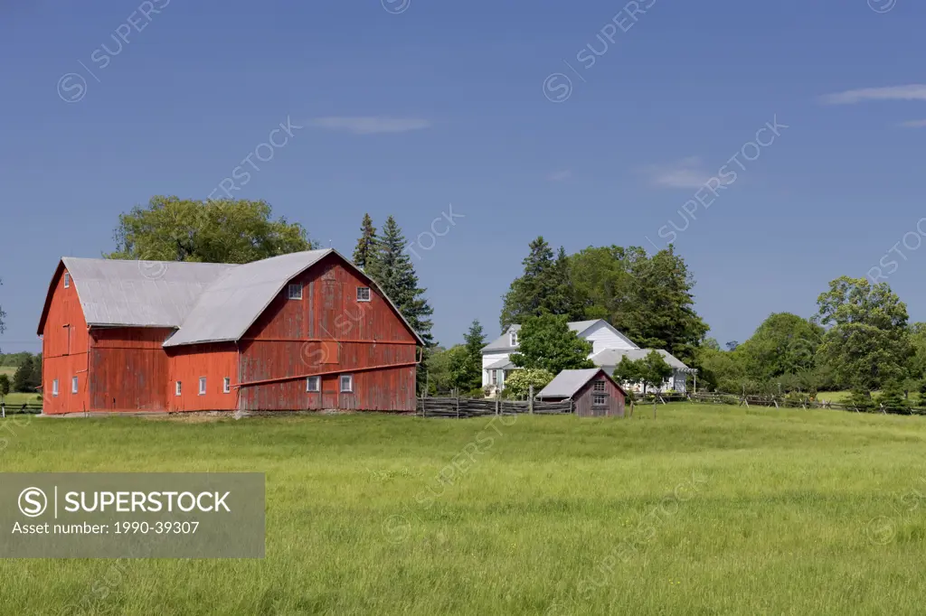Red barn and farmhouse in Cherry Valley, Prince Edward County, Ontario, Canada.