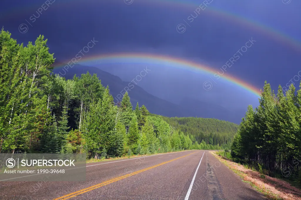 Rainbow over the Icefields Parkway in Jasper National Park during a spring rainstorm