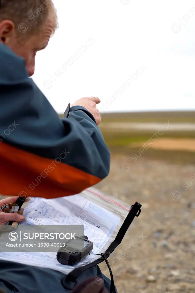Man with GPS, King William Island, Nunavut, Canada