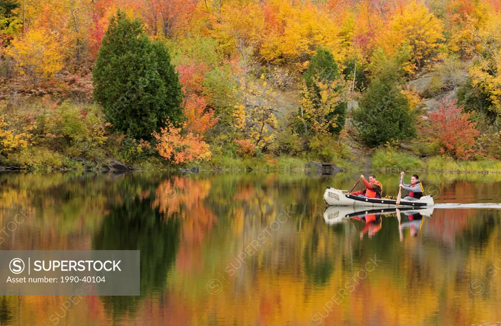 Two fisherman paddling canoe on Vermilion River. Greater Sudbury, Ontario, Canada.