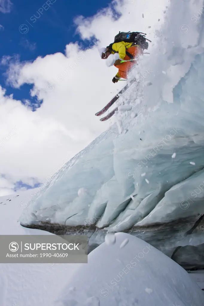 A backcountry skier airs off a crevasse in Mount Assiniboine, Mount Assiniboine Provincial Park, British Columbia, Canada