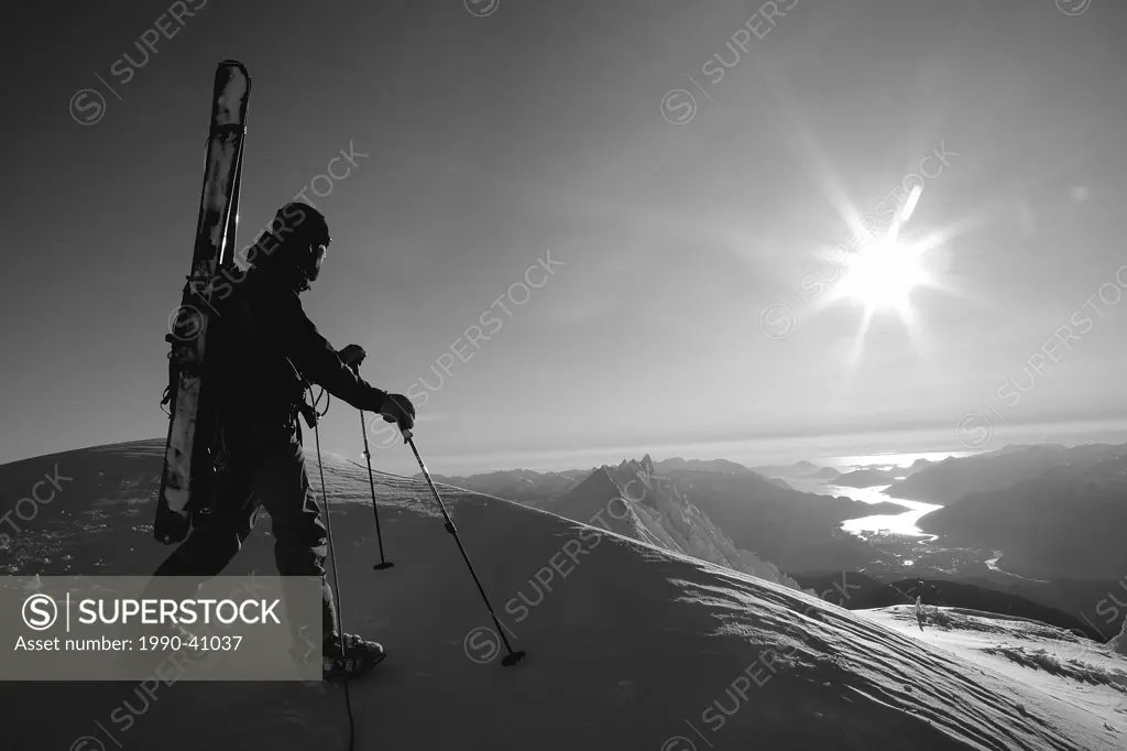 Man looking at the view on Mount Garibaldi, Coast Mountains, British Columbia, Canada.