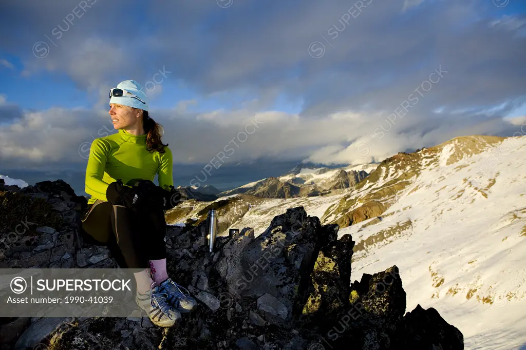 Woman runner resting on Brohm Ridge near Squamish, British Columbia, Canada.