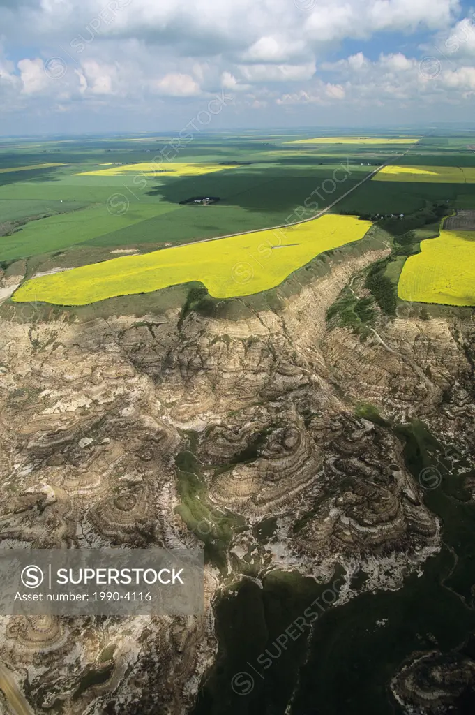aerial of badlands with farmlands beyond, Alberta, Canada