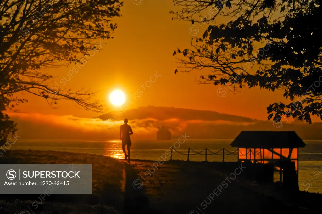 jogger at sunrise, Stanley Park, Vancouver, British Columbia, Canada