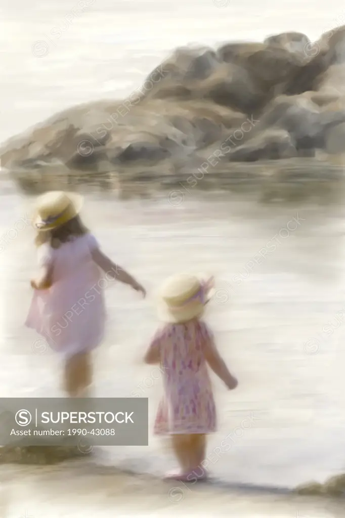 Dreamy beach scene with two little girls waiting in the ocean.