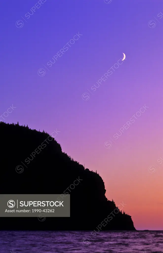 Crescent moon over Old Woman Bay at sunset on Lake Superior in Ontario´s Lake Superior Provincial Park