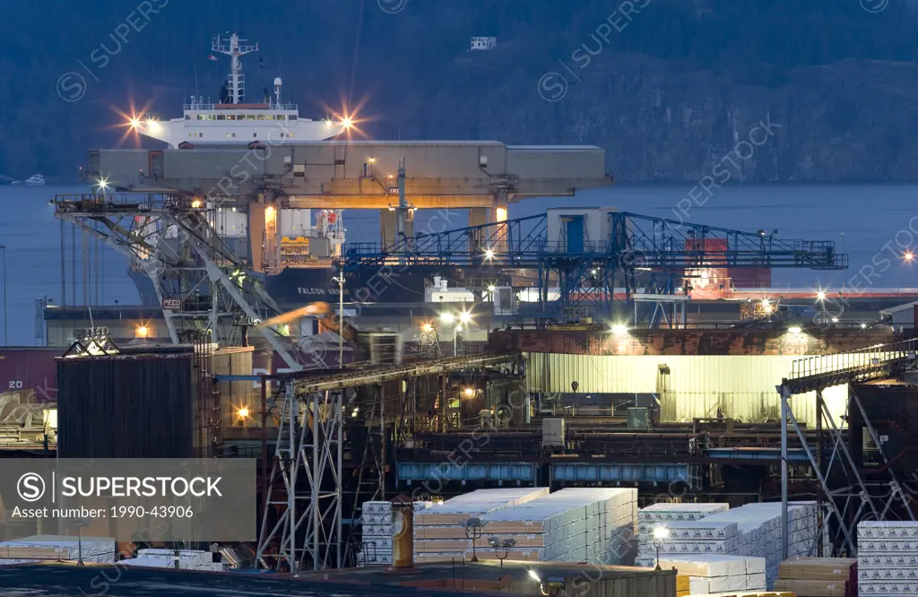 A container ship is loaded with supplies from Campbell River´s Elk Fallls Mill located within Discovery Passage. Campbell River, Vancouver Island, Bri...