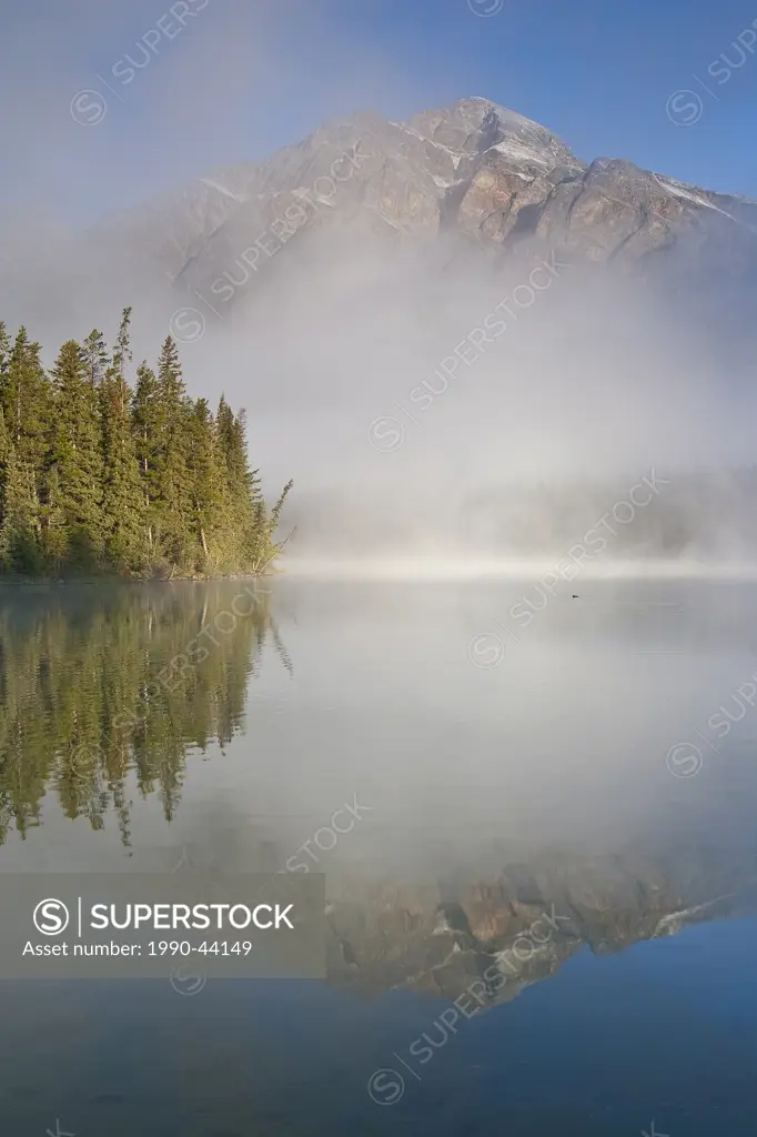 Pyramid Lake with Pyramid Mountain partly obscured by mist, Jasper National Park, Alberta, Canada
