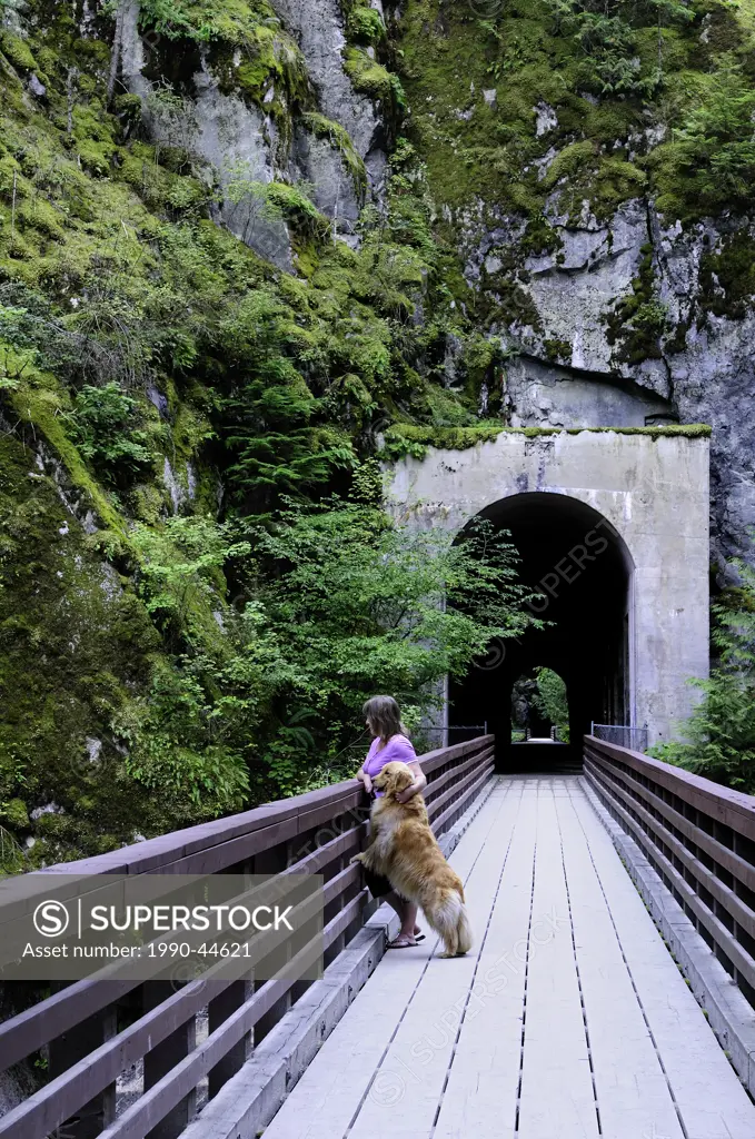 Woman and her dog enjoying the scenery at the Othello Tunnels, British Columbia, Canada.