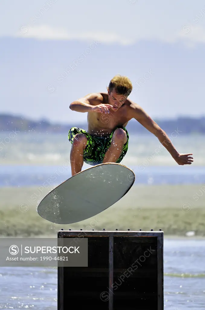 Skimboarder, Nick Fraser, model release gets some air at a jump during the 2010 Island Skim Session at Witty´s Lagoon Regional Park in Victoria, Briti...