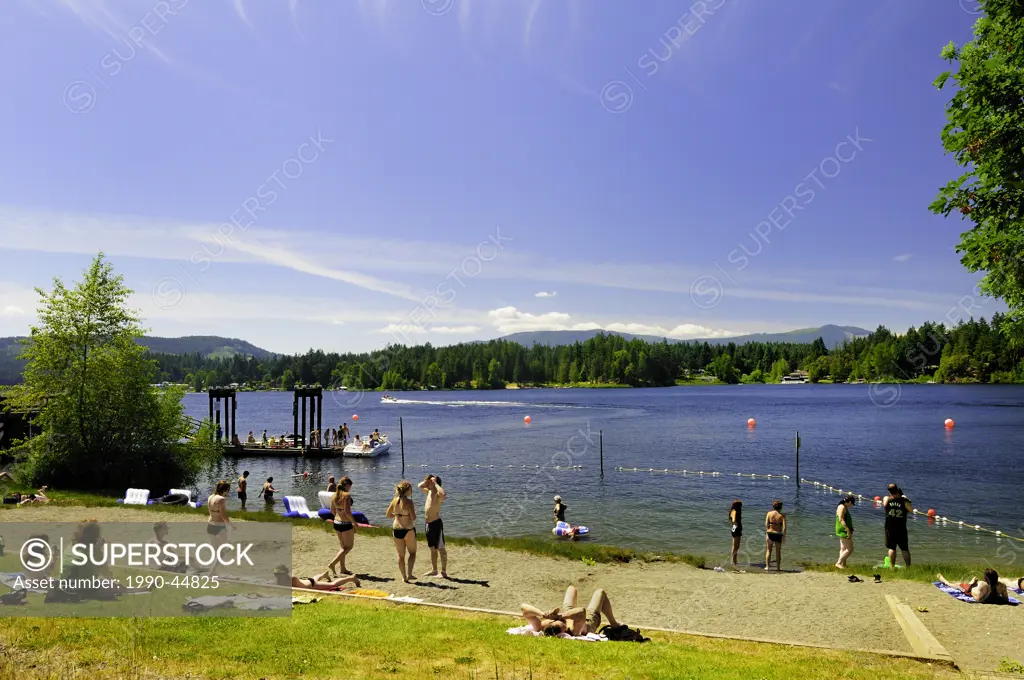 People enjoying boating and the beach at the Government Wharf on Shawnigan Lake, British Columbia, Canada.