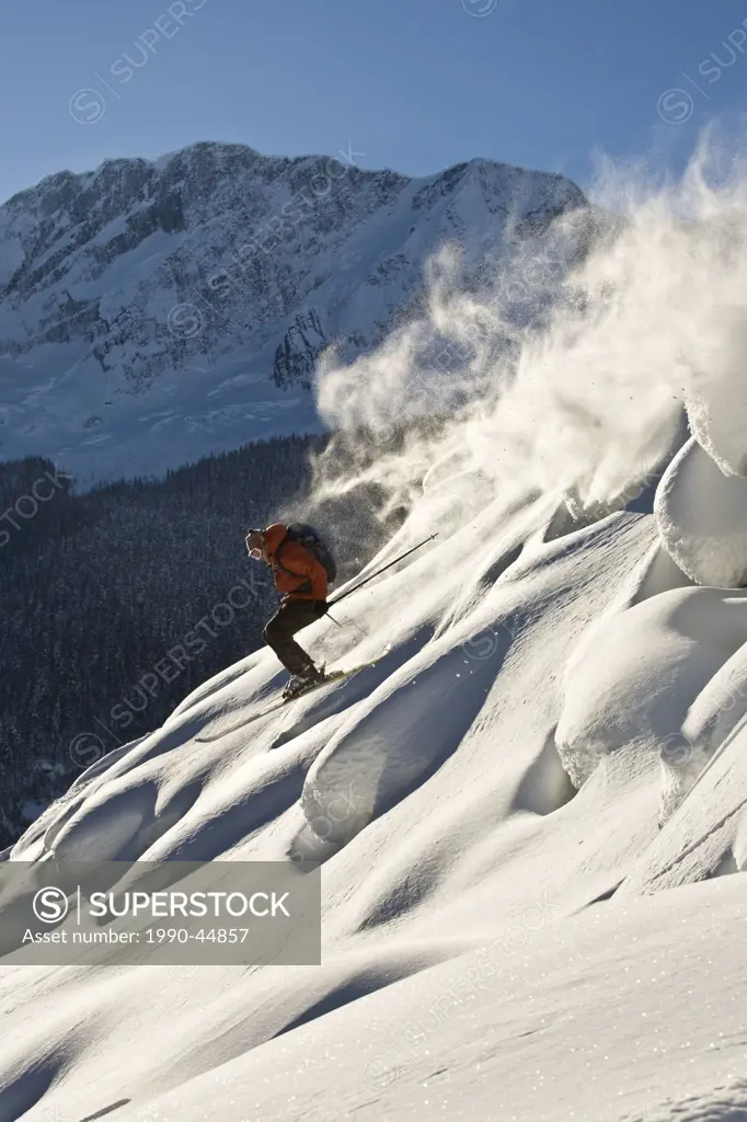 A male freeskier backcountry skiing in Roger´s Pass, Glacier National Park, British Columbia, Canada