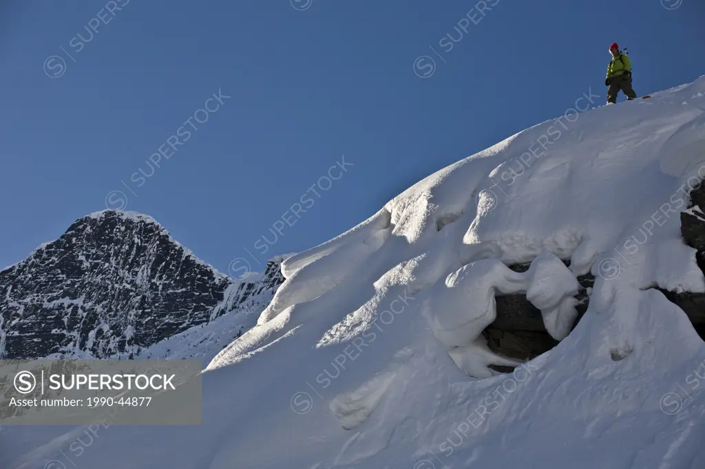 A young man splitboarding in the backcountry of Roger´s Pass, Glacier National Park, British Columbia, Canada